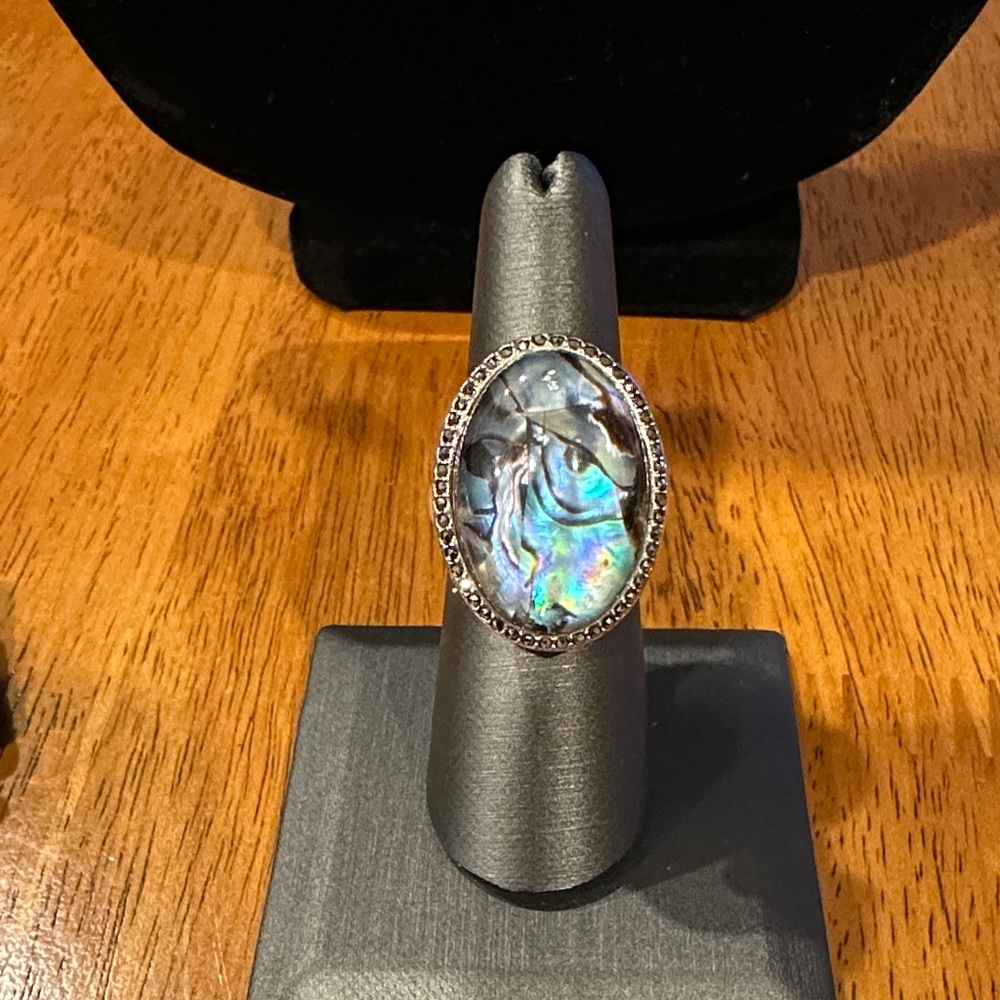 Resin over Abalone Oval Ring. Silver Hardware, and black Crystals.